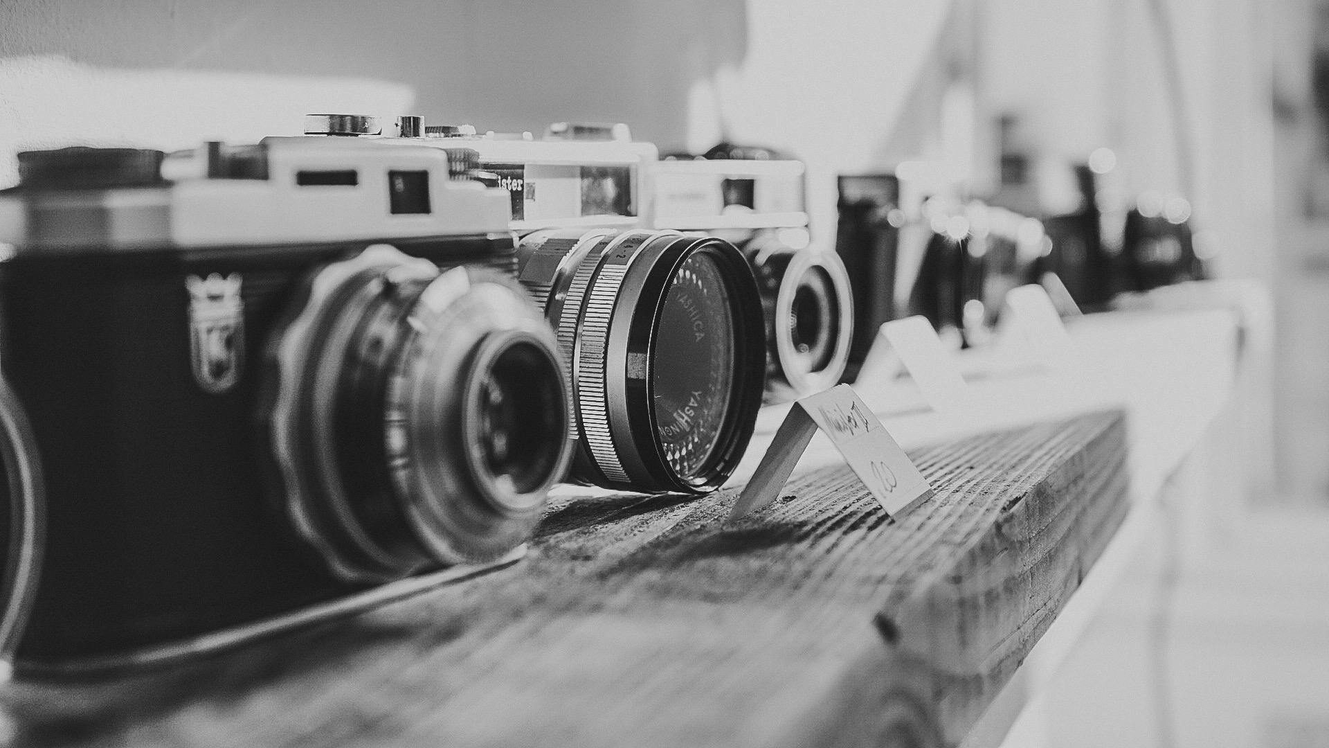 Capture of vintage cameras displayed in black and white, emphasizing nostalgia and classic design.